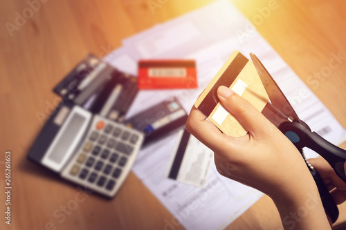 Photography women use scissors to cut credit cards in hand with many credit card and stateme