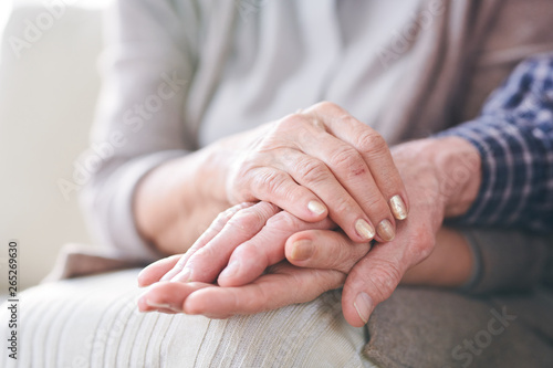 Hands of mature couple