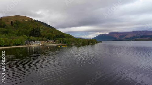Aerial depiction of the beautiful village of Luss on the banks of Loch Lomond, featuring The Lodge on the Lake and Ben Lomond in the background.
