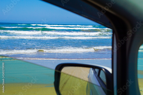 The sea seen from the window of a car running on the beach. ビーチを走る車の窓から見た海