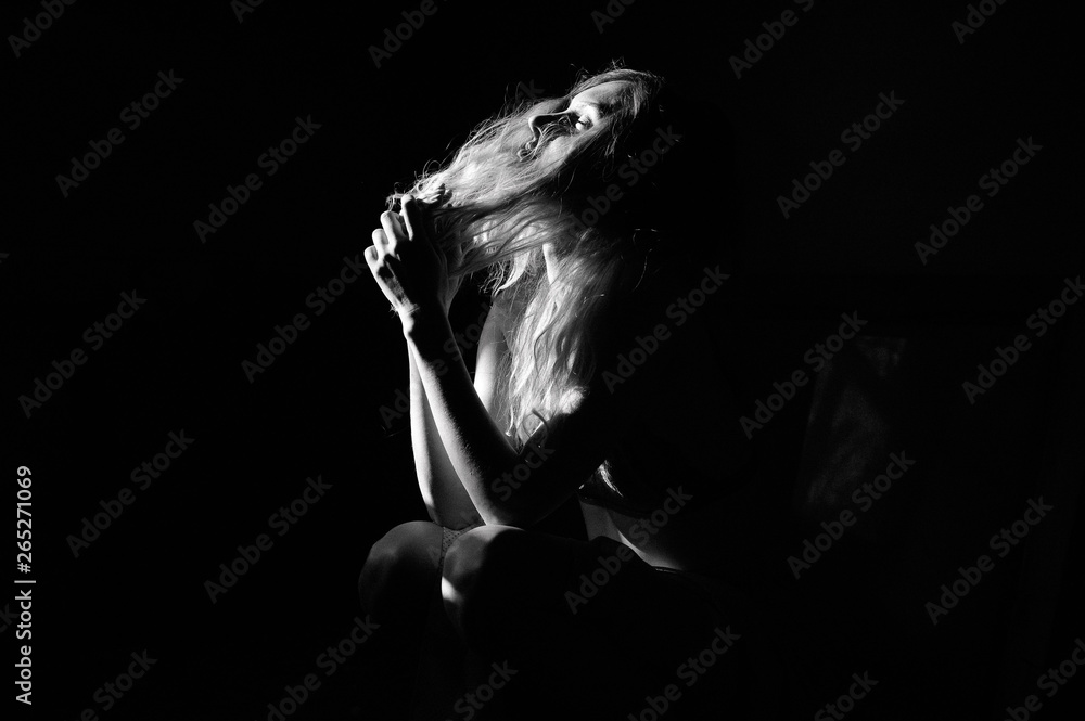 young blond woman in red bra posing standing