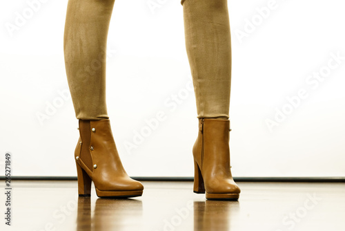 Woman wearing suede leggings and high heels