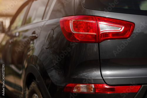 Back view of new black car. Closeup headlights of car. © VAKSMANV