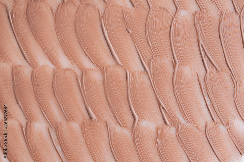 Fototapeta premium Beige smear of foundation texture. Cosmetics concept isolated on white background.