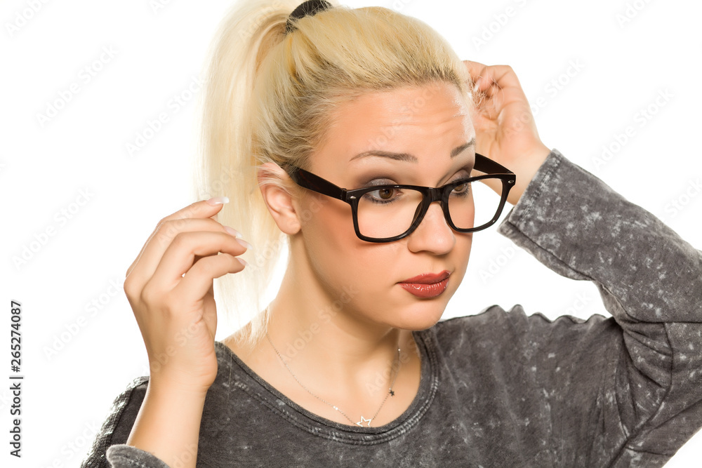 portrait of beautiful young blonde with glasses on white background