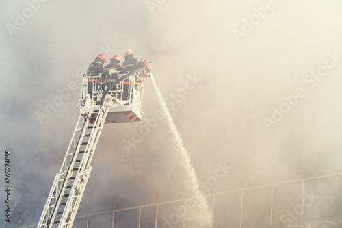 Firefighters on the stairs extinguish a big fire photo