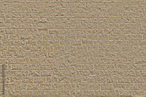 Beige brick wall texture. Rough masonry of stone blocks. Brick background of light brown limestone.