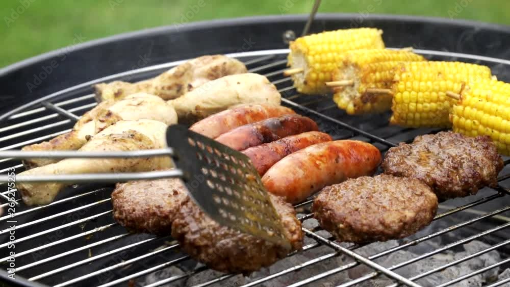 Close Up Of Flame Grilled Sausages Burgers And Chicken On Outdoor Barbecue Grill Close Up Of Flame Grilled Sausages Burgers And Chicken On Outdoor Barbecue Grill