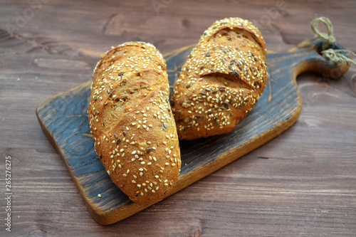 Bread sprinkled with sesame seeds on a wooden table. The concept of healthy organic food.