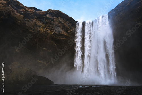 Fototapeta Naklejka Na Ścianę i Meble -  Beautiful scenery of the majestic Skogafoss Waterfall in countryside of Iceland in summer. Skogafoss waterfall is the top famous natural landmark and tourist destination place of Iceland and Europe