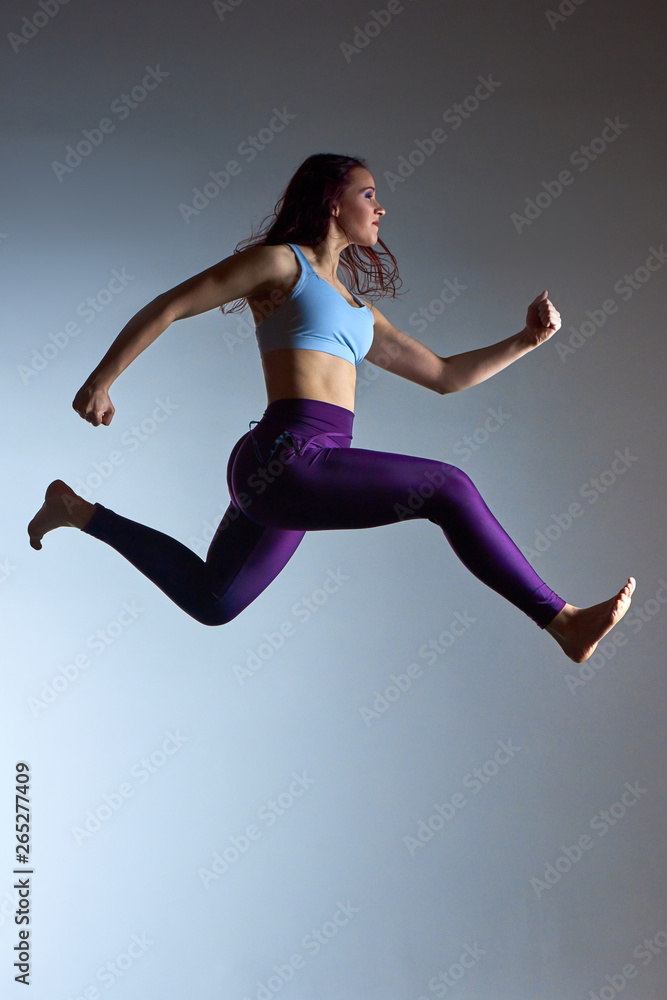 athletic jumping girl studio shot