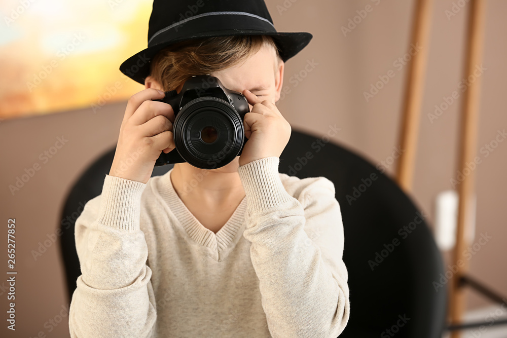 Cute little photographer with professional camera at home Cute little photographer with professional camera at home