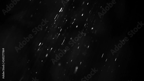 rain drops falling through light at dark background photo