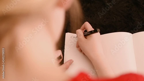 Girl doing homework on the couch, top view