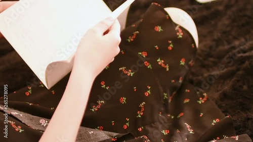 Girl doing homework on the couch, top view
