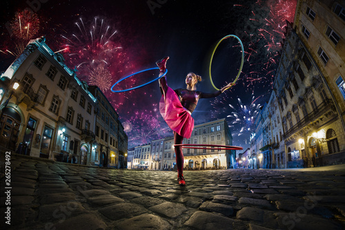 Night street circus performance whit clown, juggler. Festival city background. fireworks and Celebration atmosphere.