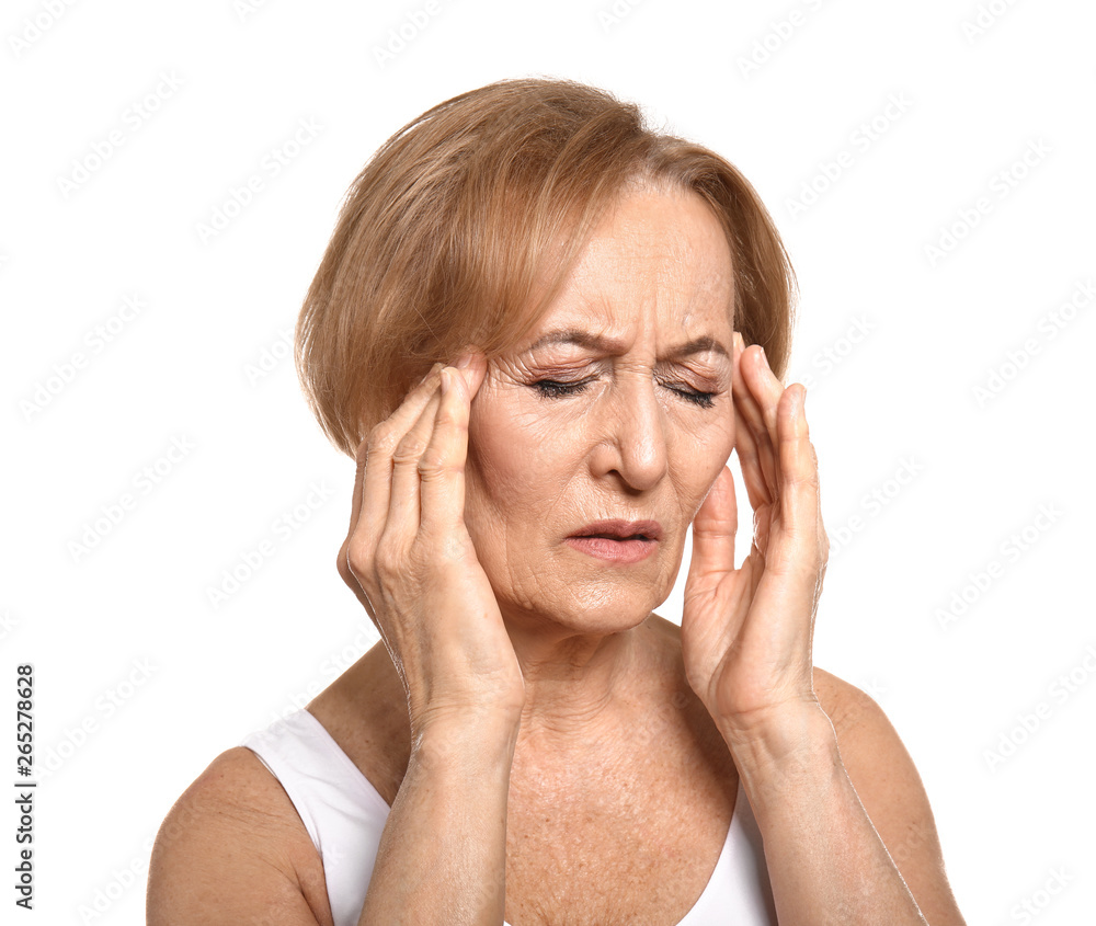 Beautiful mature woman suffering from head ache against white background