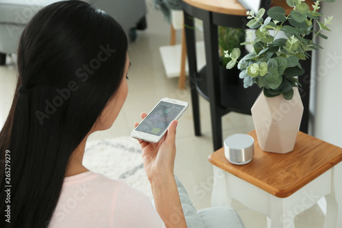 Young Asian woman using app...
