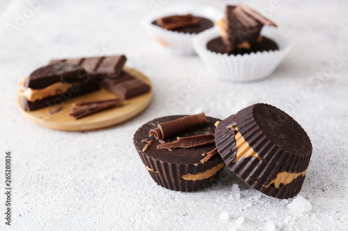Tasty chocolate peanut butter cups on table