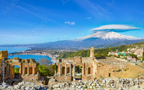 Ancient Greek theatre in Taormina on background of Etna Volcano, Italy