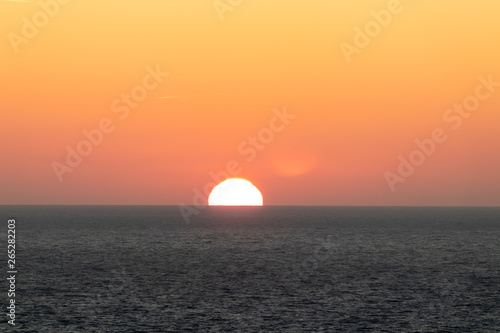 Fototapeta Naklejka Na Ścianę i Meble -  Sun on horizon over the Irish sea.