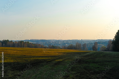 Landscape with the image of spring countryside in Tula region in Russia at sunset