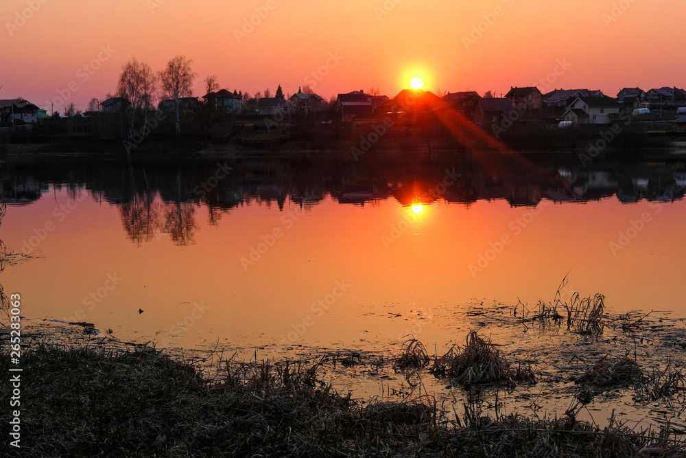 Fototapeta premium Landscape with the image of spring lake at sunset