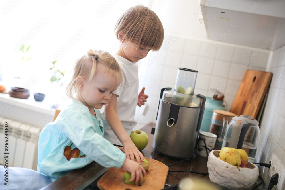 children with juicer squeeze out juice from apples children with juicer squeeze out juice from apples