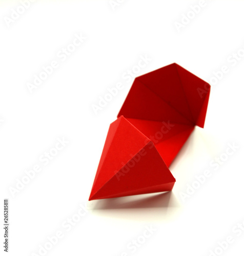Geometric shape cut out of paper and photographed on white background. Geometry net of Hexagonal Dipyramid. 2-dimensional shape that can be folded to form a 3-dimensional shape or a solid.