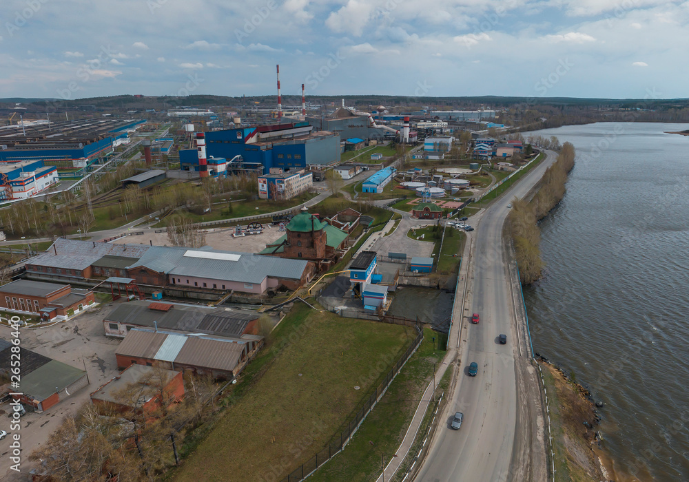 Pipe plant and pond in Polevskoy city, Aerial, spring, cloudy