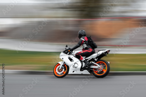Riding a motorcycle, a man speeds on the track. © Aliaksandr Marko