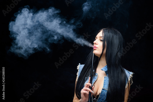 sexy woman smoking cigar. Bad habit. Woman vapor. unhealthy addiction. Tabacco drug. exhale smoke on black background. hookah bar. Electronic cigarette. copy space. Choose Not To Use.