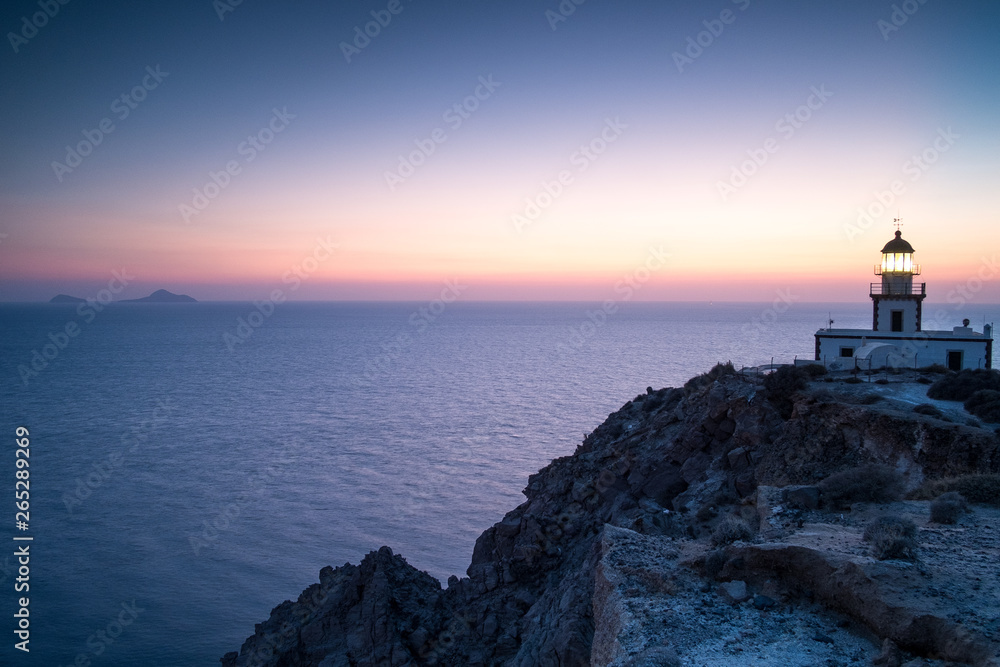 Sunset and lighthouse, Santorini, Greece