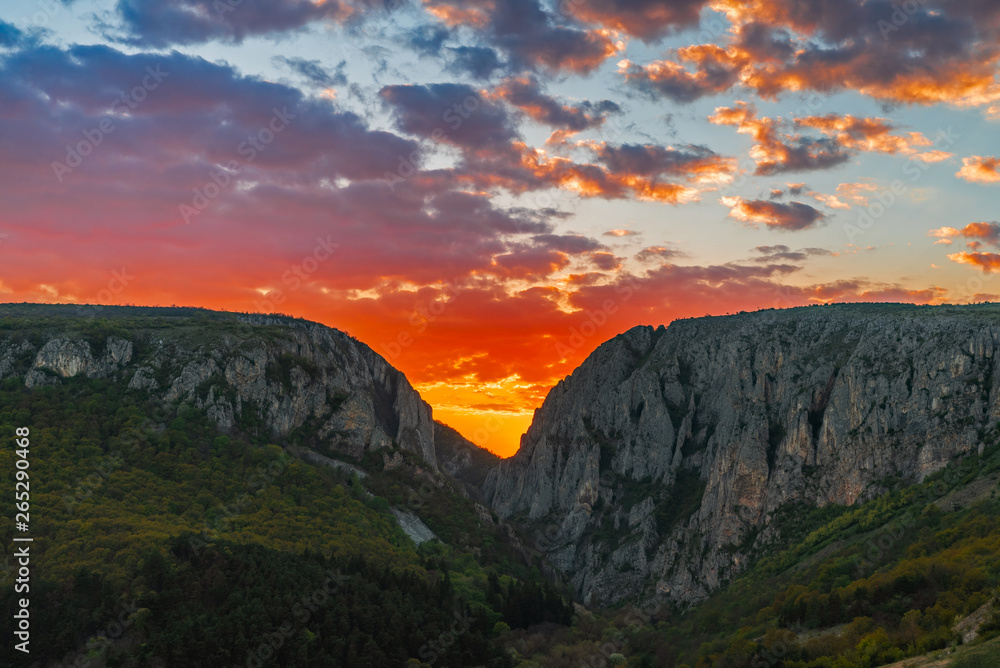 Sunset between mountains peaks, Turda Gorge, Romania 