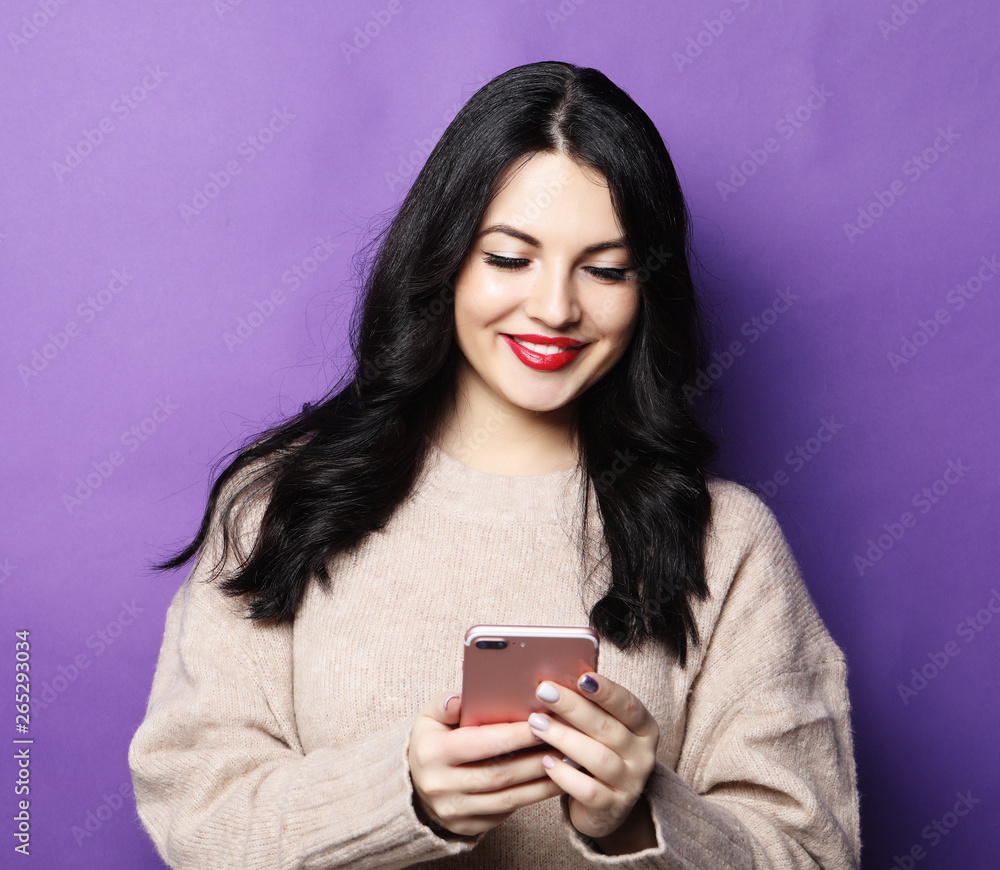 young woman with long hair, holds modern cell phone young woman with long hair, holds modern cell phone