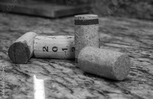 Generic wine corks arranged on marble bar counter top in black and white for wall art decoration photo printing