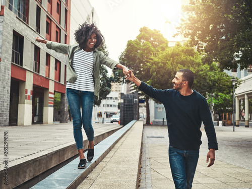 Photography Cheerful couple enjoying walking in the city