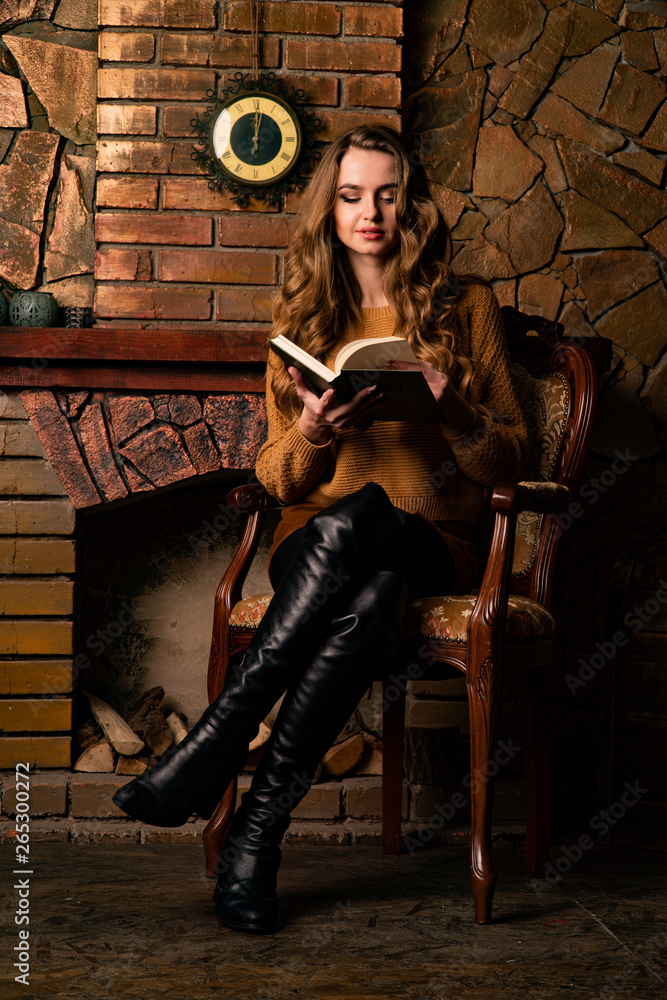 Φωτογραφία A young girl sitting in a chair near a fireplace looking determined