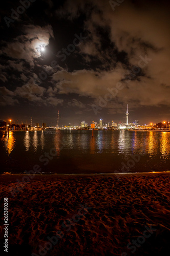 Auckland City and Sky Tower from beach at Night