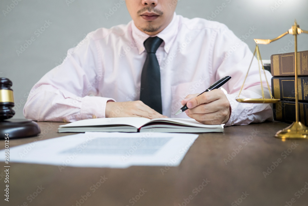 lawyer judge reading documents at desk in courtroom working on wooden desk background. gavel golden Weight. and soundblock of justice. lawyer judge reading documents at desk in courtroom working on wooden desk background. gavel golden Weight. and soundblock of justice.