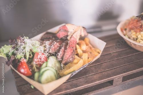 Streetfood, Flanksteak mit Pommes frites, Käsesauce, Salat mit Parmesan photo