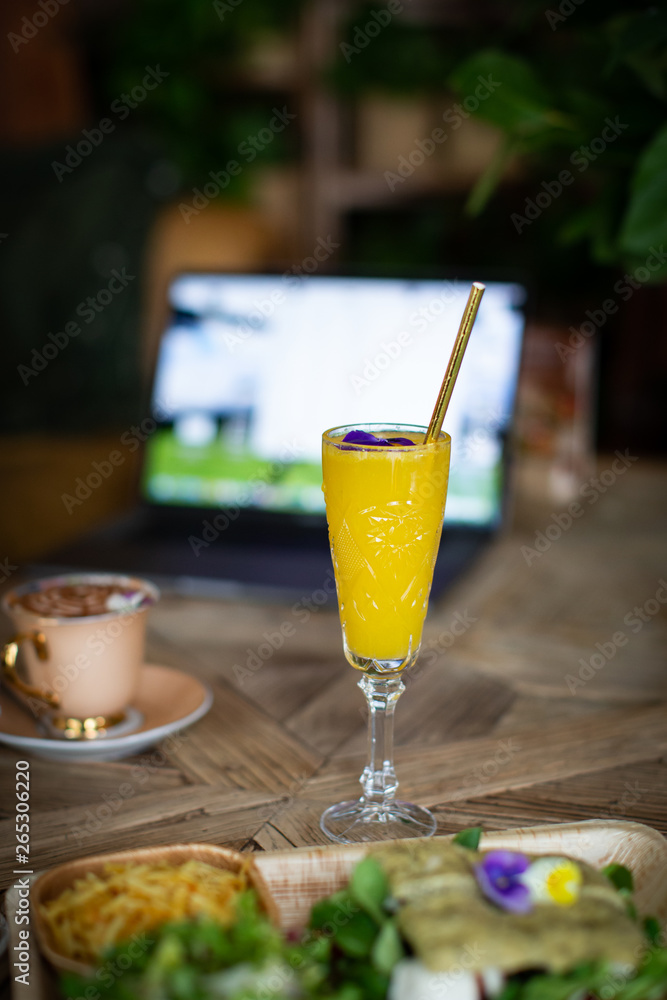 mimosa cocktail with laptop and coffe