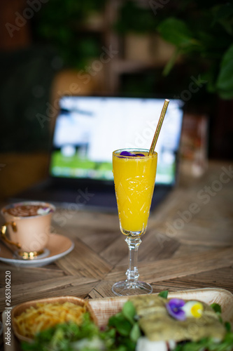 mimosa cocktail with laptop and coffe