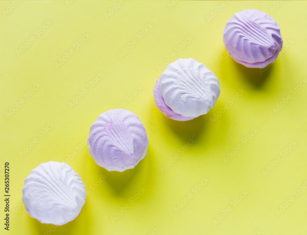 a delicious dessert, a delicate white and pink marshmallow on a yellow background a delicious dessert, a delicate white and pink marshmallow on a yellow background