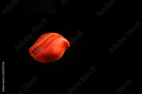 closeup top view of small red oval-shaped chocolate candy