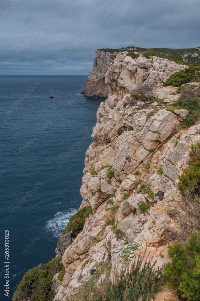 Capo Caccia, a rocky outcrop set in a protected ecosystem near the town of Alghero, Sardinia, Italy. featuring. Scenic hiking routes, diving sites & caverns with archaeological remains