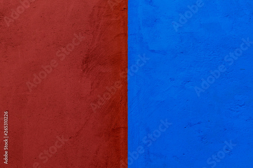 Red and blue concrete wall texture, divided by half