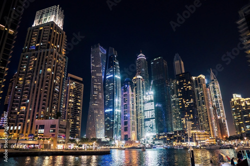 Dubai at night. Dubai marina, skylines Dubai Marina. Skyscrapers and Mosque of Dubai Marina in the evening. Ships and boats.