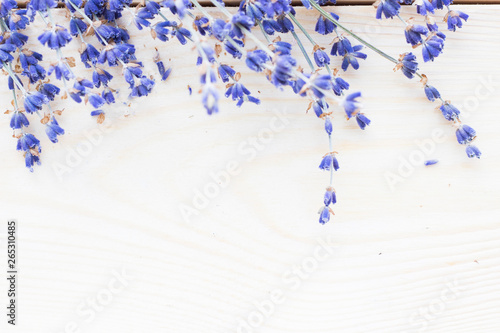 Spa and wellness setting with lavender flowers, sea salt, oil in a bottle, aroma candle on wooden white background