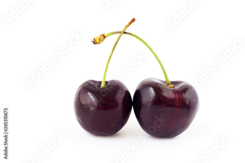 Two fresh cherries ,red cherry  isolated on a white background © Thapanon Phoonchai